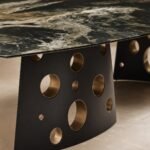Detaliu generat al blatului grafit-verde și al perforațiilor căptușite cu metal champagne