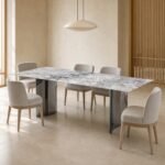 Masă de dining Vela cu blat marmorat deschis și baze metalice pliate, ambient de dining generat