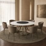 Masă de dining rotundă Filigrana cu blat mineral alb și soclu tubular din bronz – ambient de dining generat
